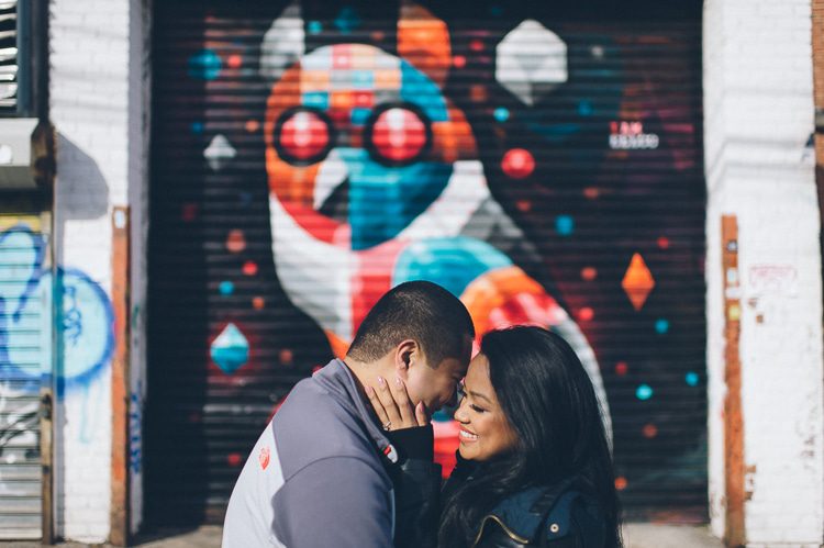 Fun Queens NYC engagement session featuring graffiti murals, silhouettes and parking garages, captured by NYC wedding photographer Ben Lau.