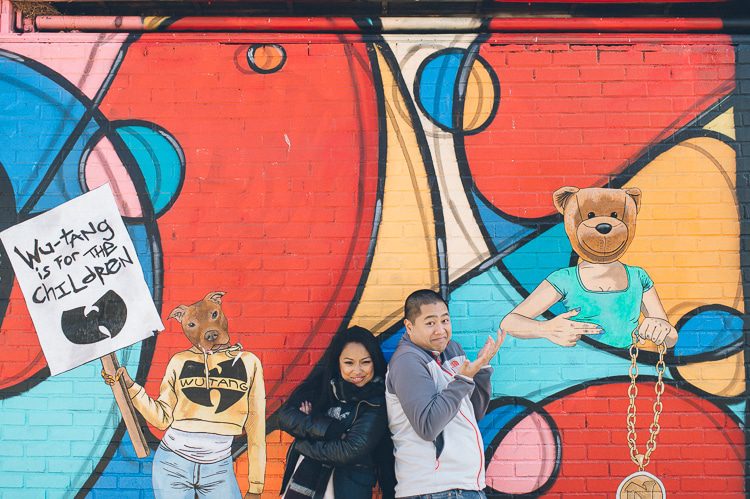Fun Queens NYC engagement session featuring graffiti murals, silhouettes and parking garages, captured by NYC wedding photographer Ben Lau.