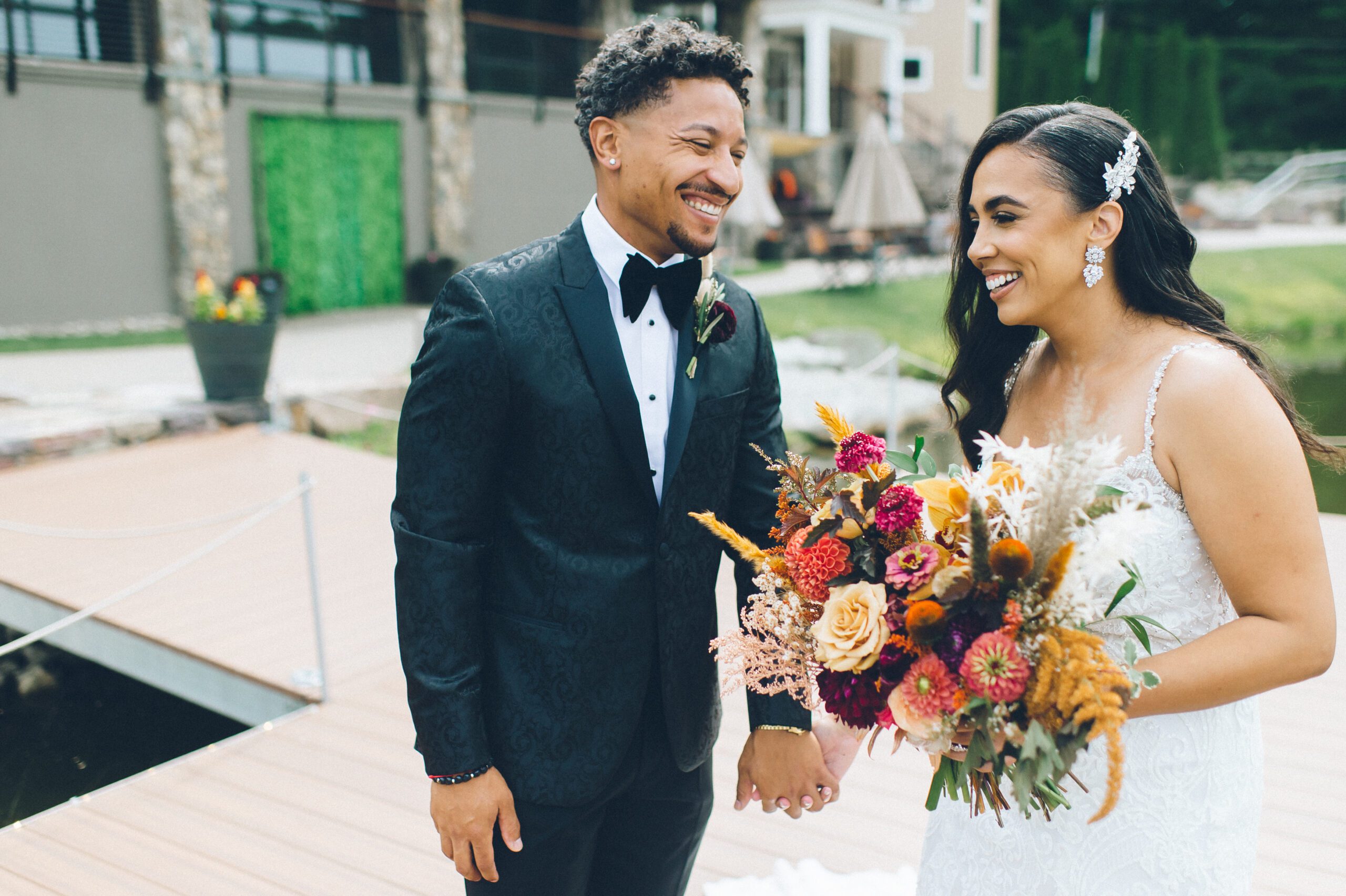 Alliee and Brandon smiling together on the dock at Rock Island Lake Club.