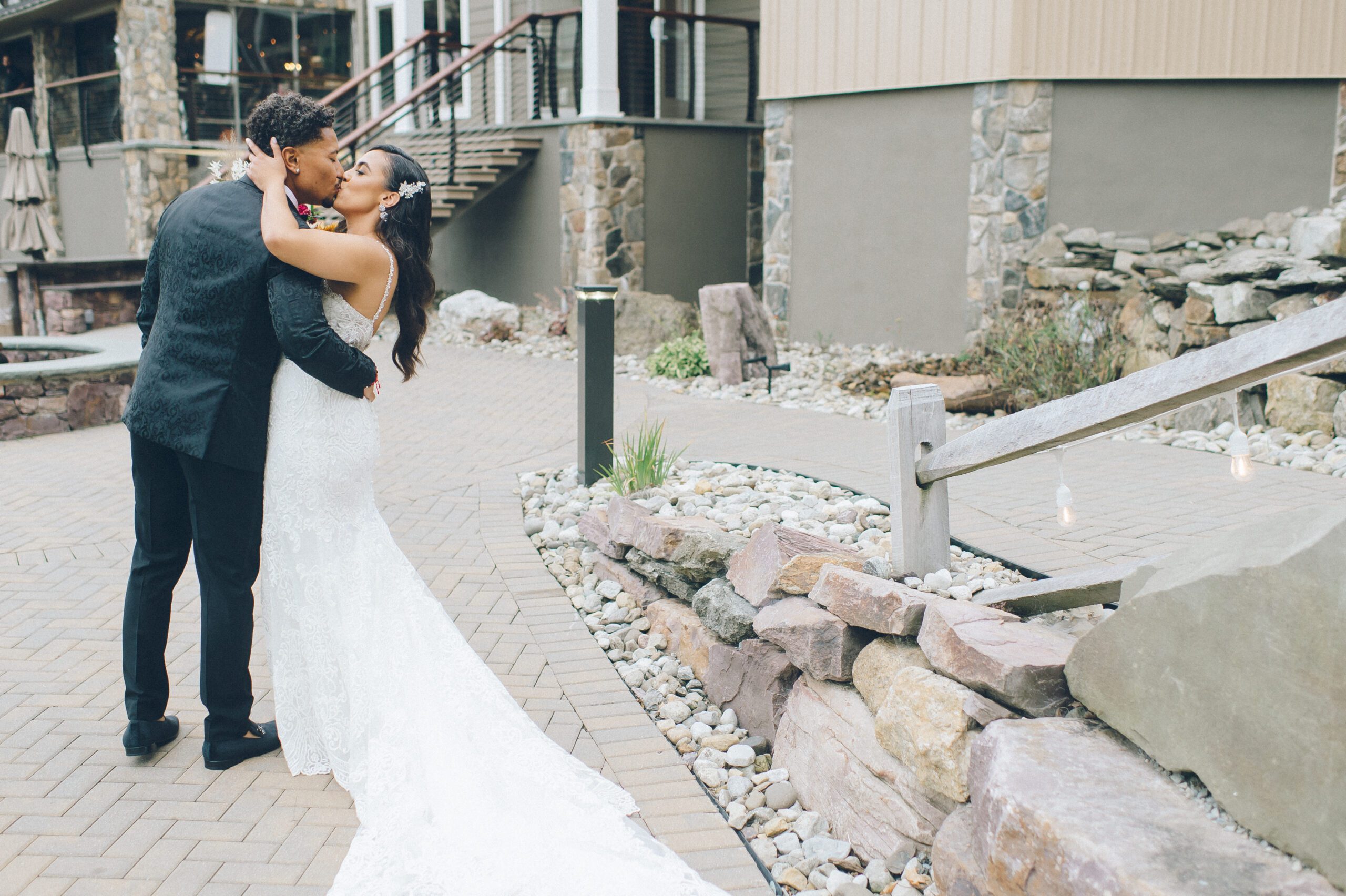 Alliee and Brandon hugging a guest after the outdoor ceremony at Rock Island Lake Club.